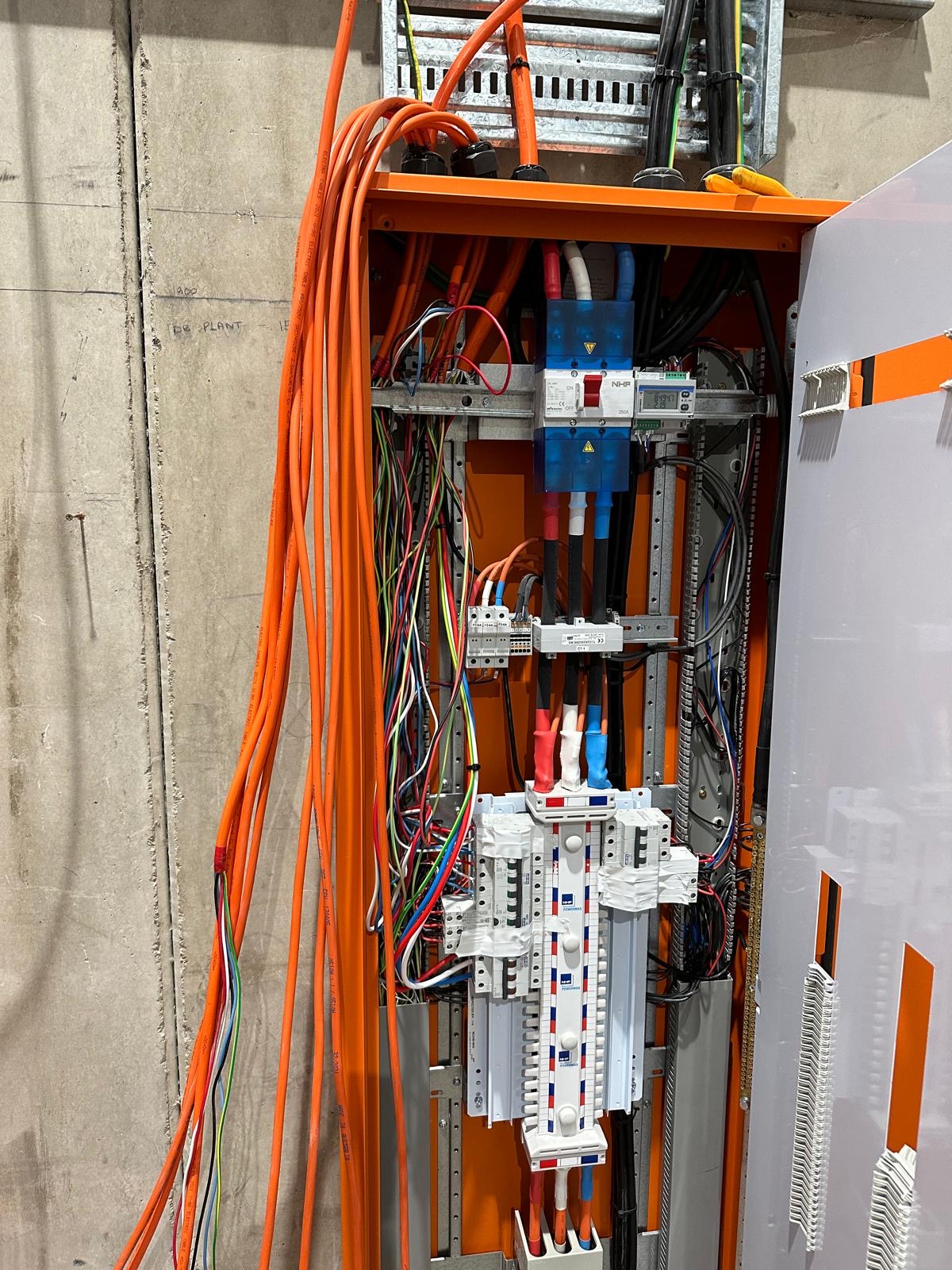 Commercial main switchboard with distribution boards and orange sub mains