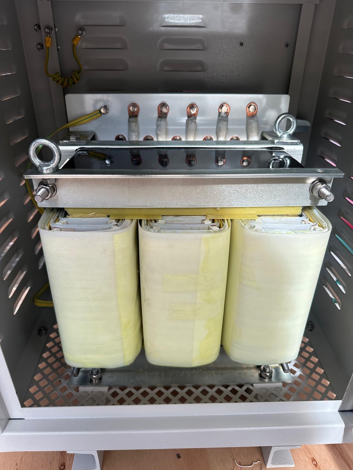 Three phase transformer installed in a ventilated enclosure